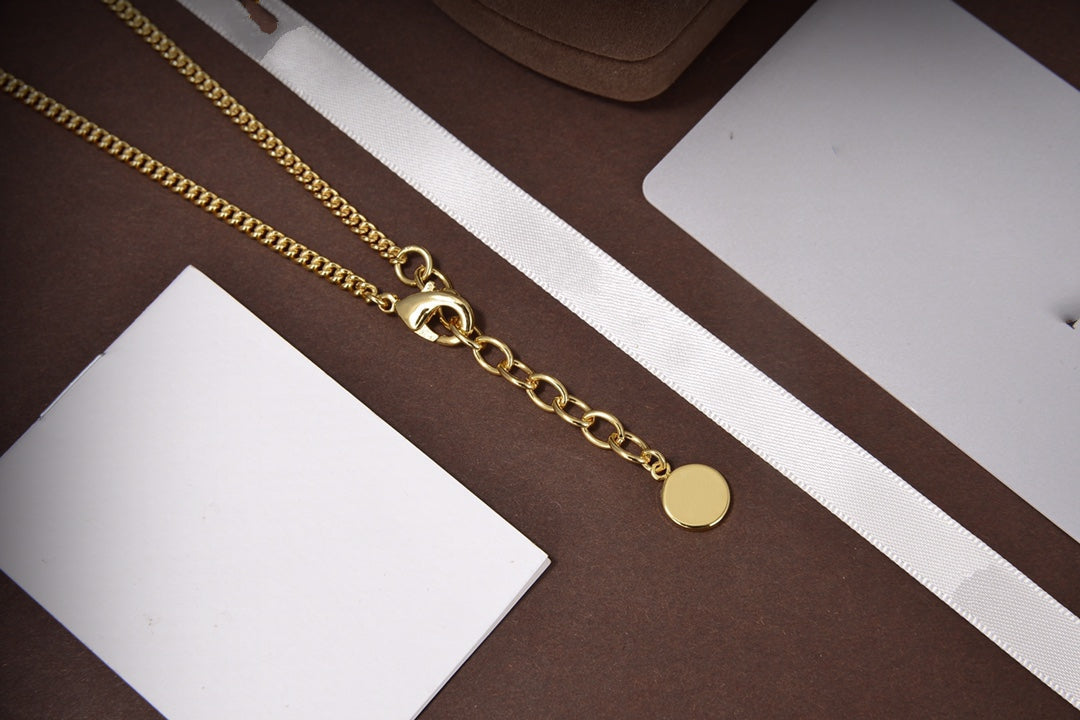 Collier étoile et boule en or et diamants