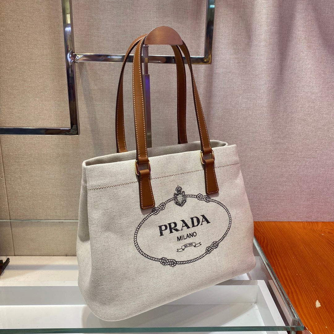 SAC CABAS 33 EN TOILE BLANCHE ET ANSE EN CUIR DE VEAU MARRON