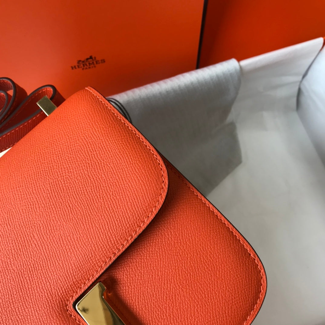 Constance 24 cuir Epsom orange rouge et accessoires dorés