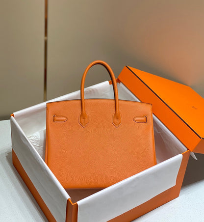 Sac HM Birkin 35 cm en cuir Togo orange et accessoires dorés