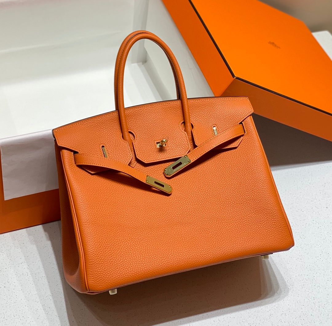 Sac HM Birkin 35 cm en cuir Togo orange et accessoires dorés
