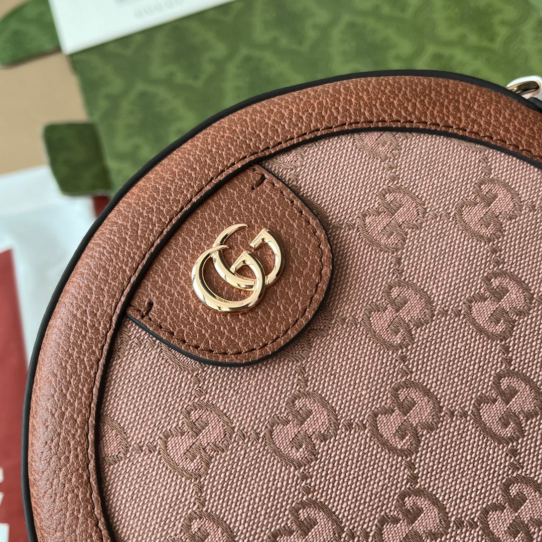 Mini sac bandoulière rond OPHIDIA 18 pouces en toile rose poudré et bordure en cuir marron