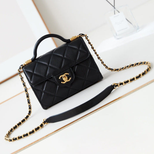 Sac à rabat 24a avec poignée supérieure 18 cm en cuir d'agneau noir et accessoires dorés