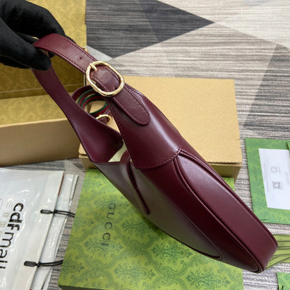 Petit sac bandoulière Jackie 27 en cuir de veau bordeaux et métal doré