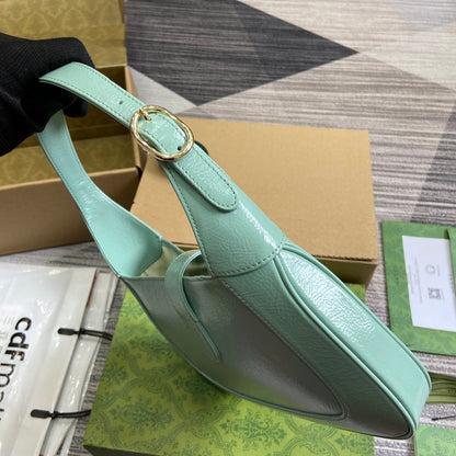 Petit sac bandoulière Jackie 27 en cuir de veau laqué craquelé vert menthe, accessoires dorés 