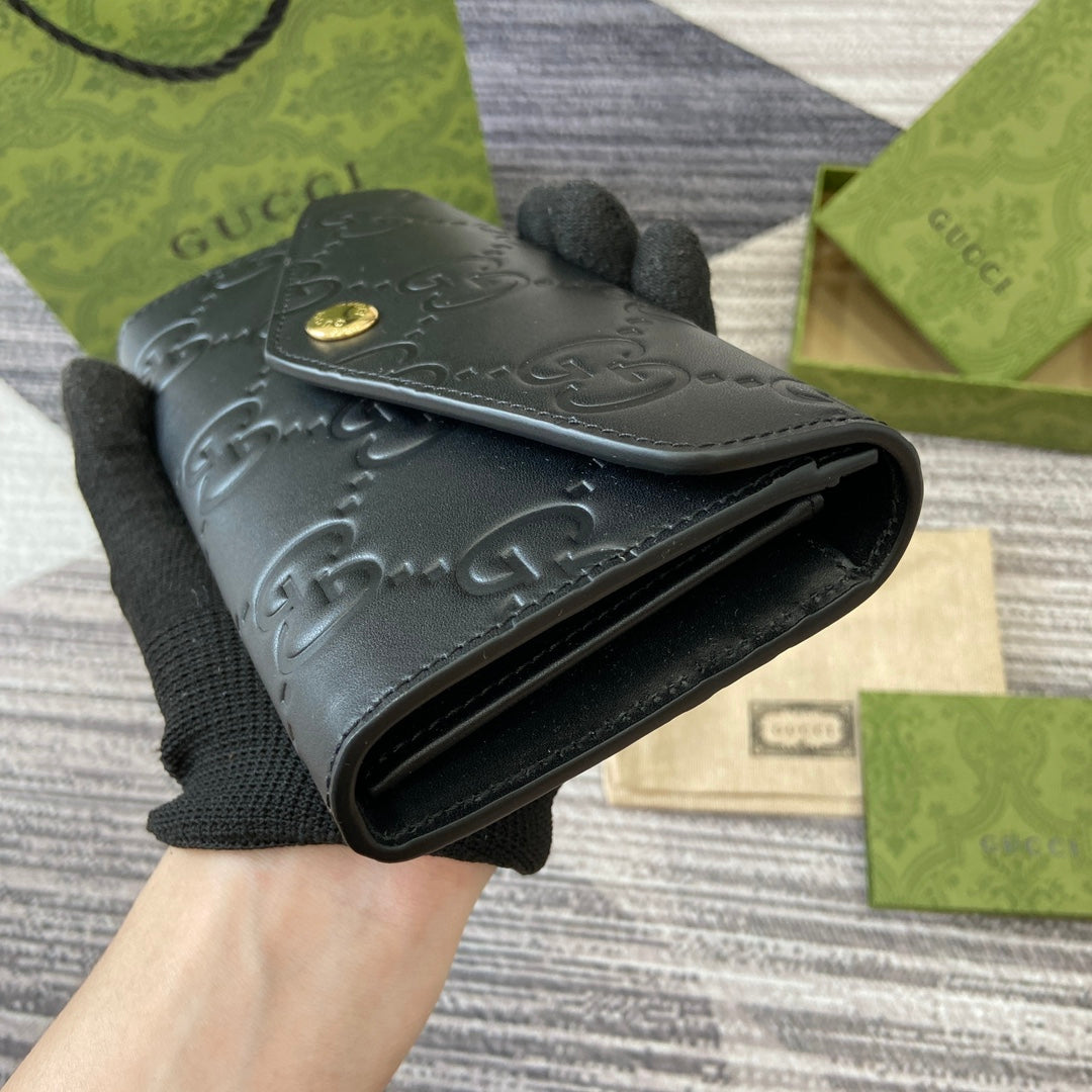 Portefeuille continental 19 en cuir de veau embossé noir, matériel doré
