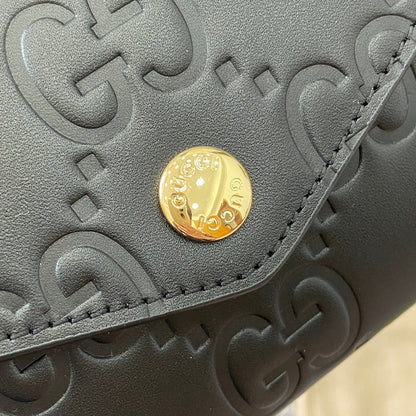 Portefeuille continental 19 en cuir de veau embossé noir, matériel doré