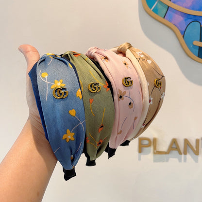 ベビーピンクのシルク製フラワープリントヘアバンド 398863