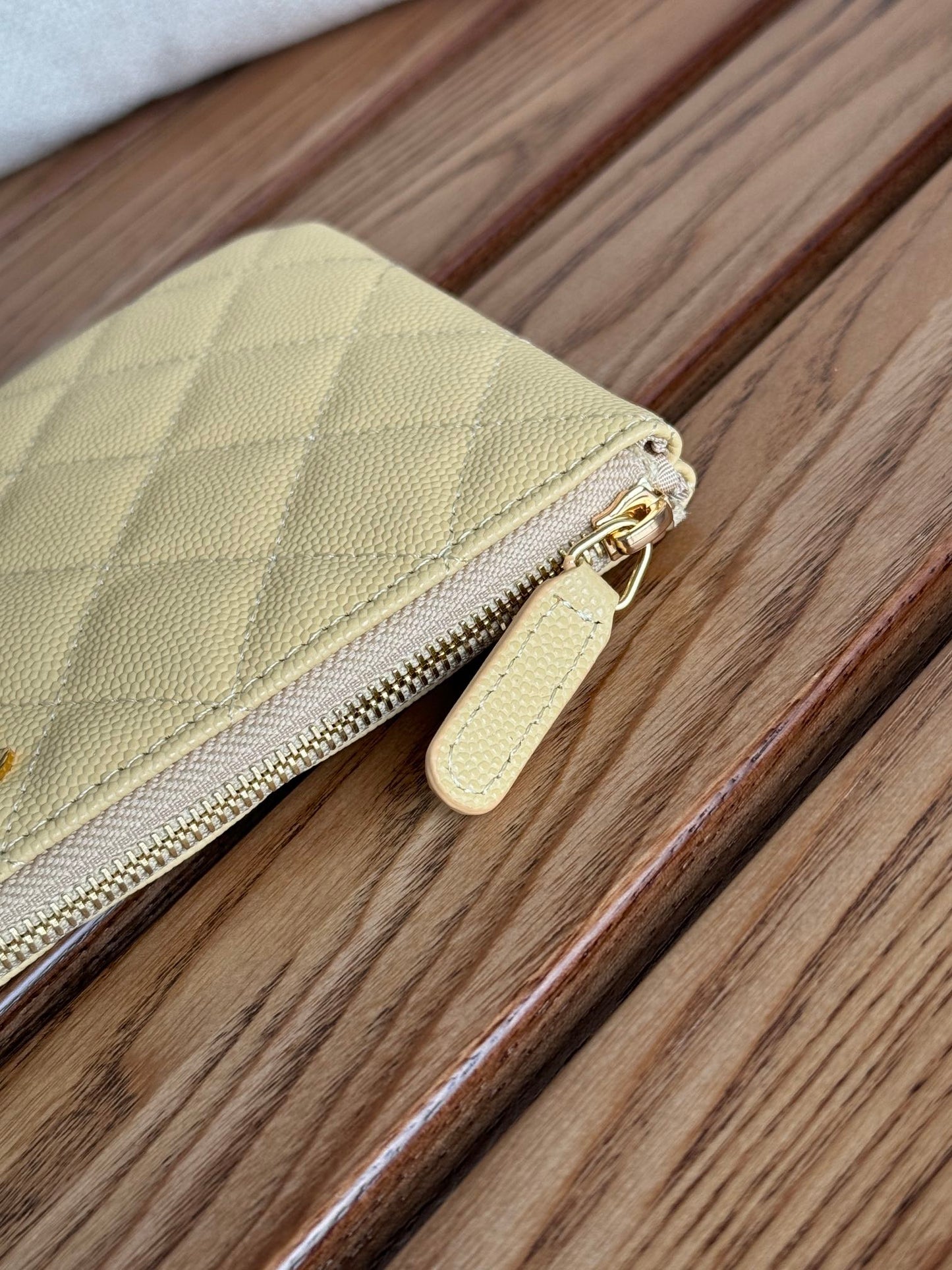 Portefeuille zippé CC 20 cm en caviar matelassé jaune clair, finitions dorées