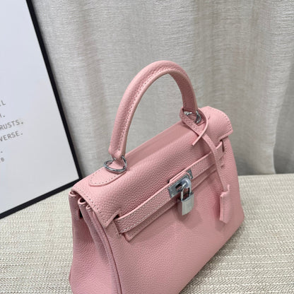Sac à main HM Kelly 25 cm en cuir Togo rose pastel avec accessoires argentés