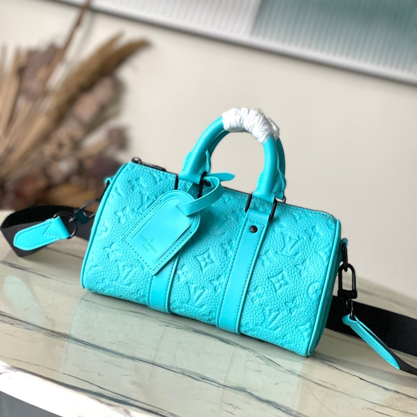 Sac bandoulière Keepall 25 en cuir de veau embossé monogramme bleu turquoise