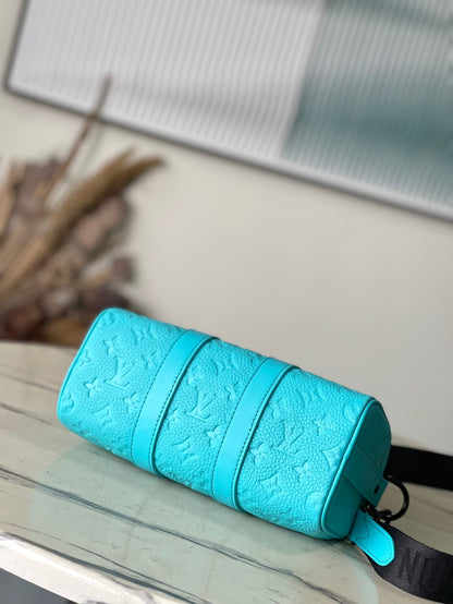 Sac bandoulière Keepall 25 en cuir de veau embossé monogramme bleu turquoise